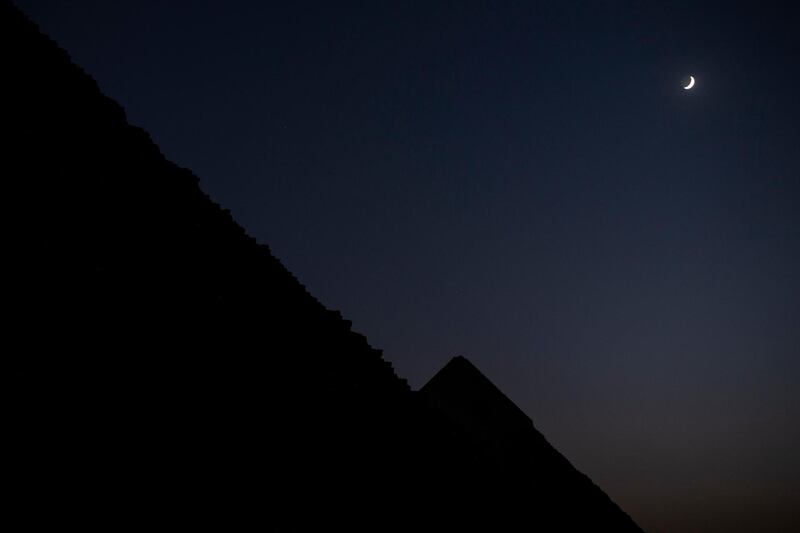 A general view of the Giza Pyramids with a crescent in the sky, Giza, Egypt, October 20, 2020, during the opening of 9 Pyramids lounge restaurant, as a part of development of Giza pyramids area by the Egyptian government with Orascom Company. EPA