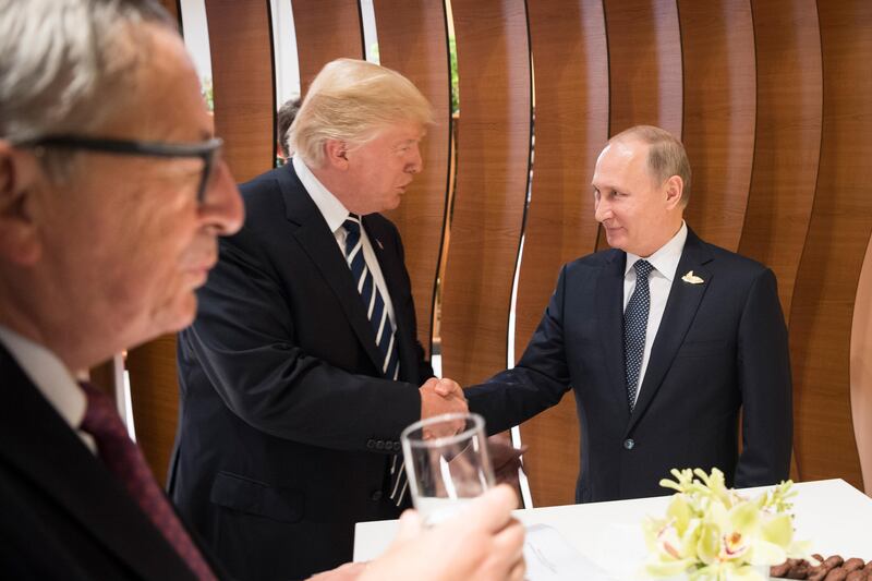 Mr Trump greets Russian president Vladimir Putin Steffen Kugler / EPA