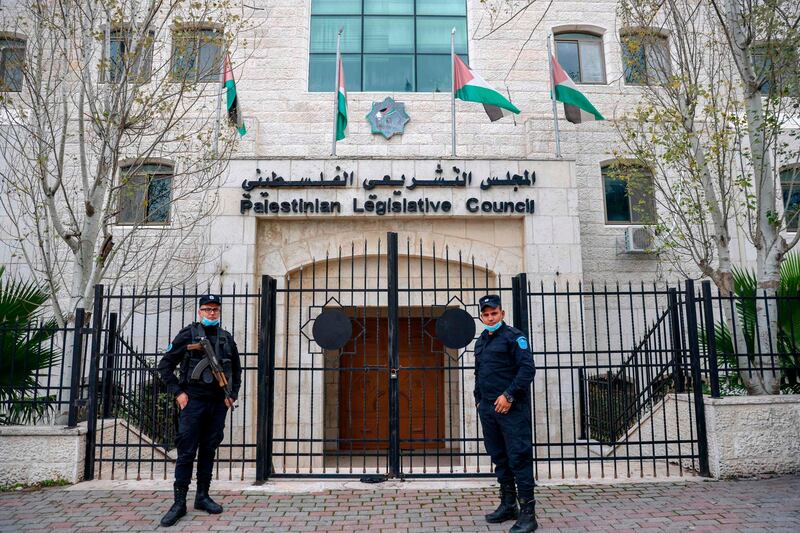 Members of the Palestinian security forces stand guard outside the  Legislative Council building in the occupied-West Bank town of Ramallah. AFP