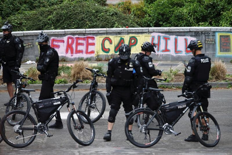 Seattle Police officers on bicycles maintain a perimeter near Cal Anderson Park while retaking the Capitol Hill Occupied Protest area. Reuters