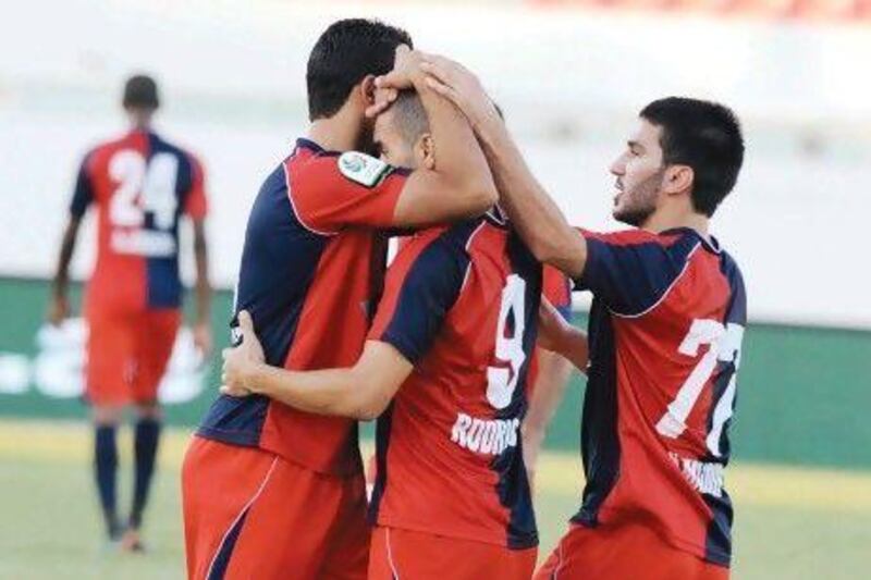 Al Shaab players celebrate a goal against Dibba Al Fujairah. Al Itihad