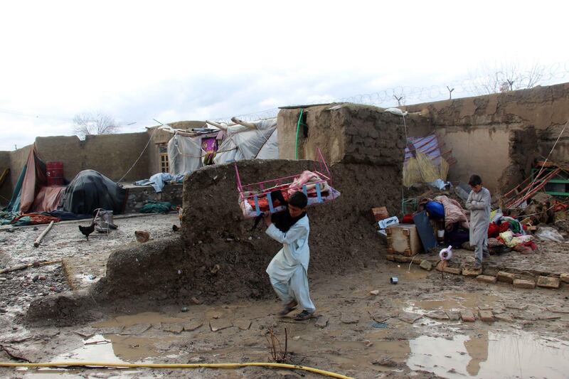 People salvage their belongings after flash floods in Kandahar, Afghanistan on March 2, 2019. EPA