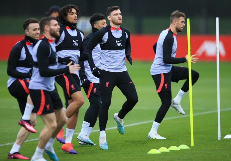 Liverpool's Andrew Robertson, centre, and teammates take part in a team training session. AFP