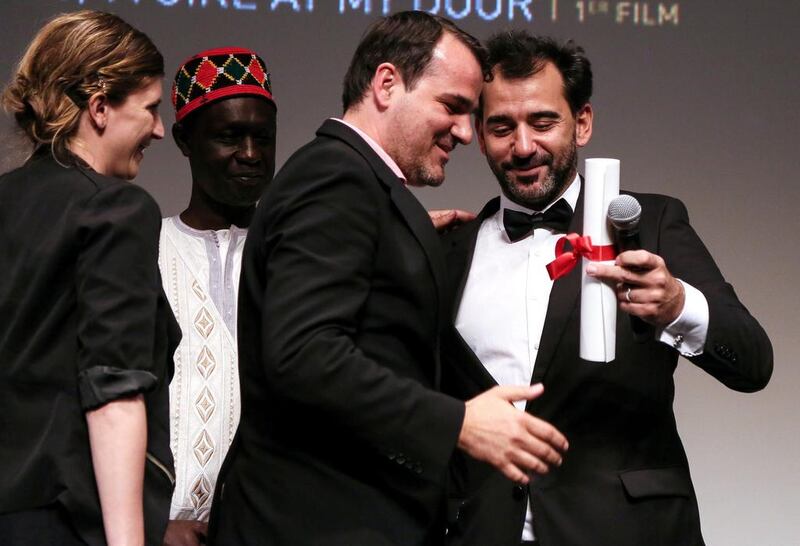 Hungarian director Kornel Mundruczo, centre, receives the top prize for his movie Feher Isten (White God) from Jury President and Argentine director Pablo Trapero, right, during the Un Certain Regard Closing Award Ceremony during the 67th annual Cannes Film Festival on May 23, 2014. Julien Warnand / EPA