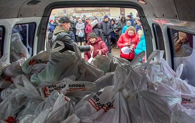Volunteers distribute humanitarian aid to residents on the outskirts of Kharkiv, Ukraine on December 16. EPA