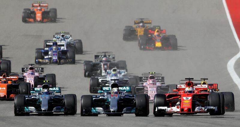 Mercedes driver Lewis Hamilton and Ferrari driver Sebastian Vettel lead the pack. Eric Gay / AP Photo