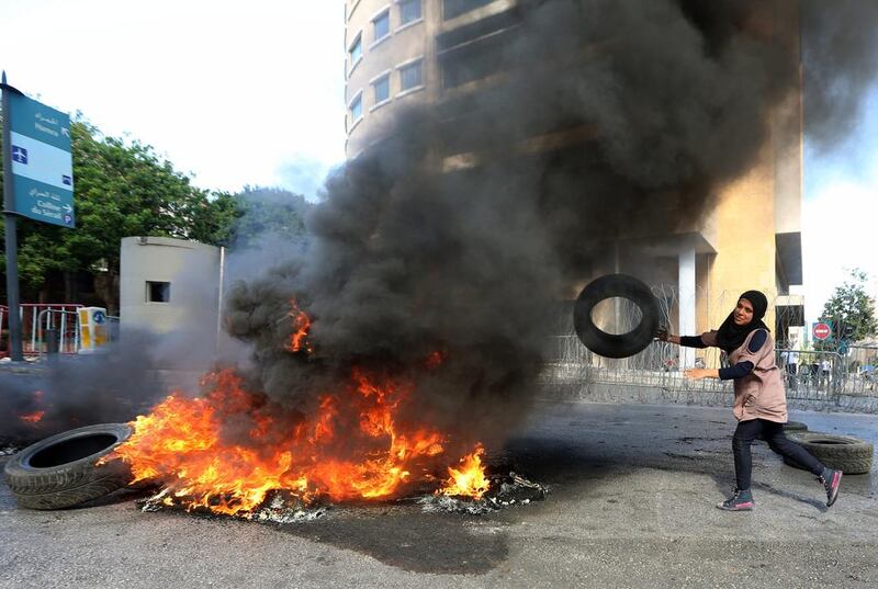 Iman Alsaid, a relative of kidnapped Lebanese soldier Khalid Hassan, burns tires during a demonstration to demand action to secure the release of soldiers held by militants. Bilal Hussein / AP Photo