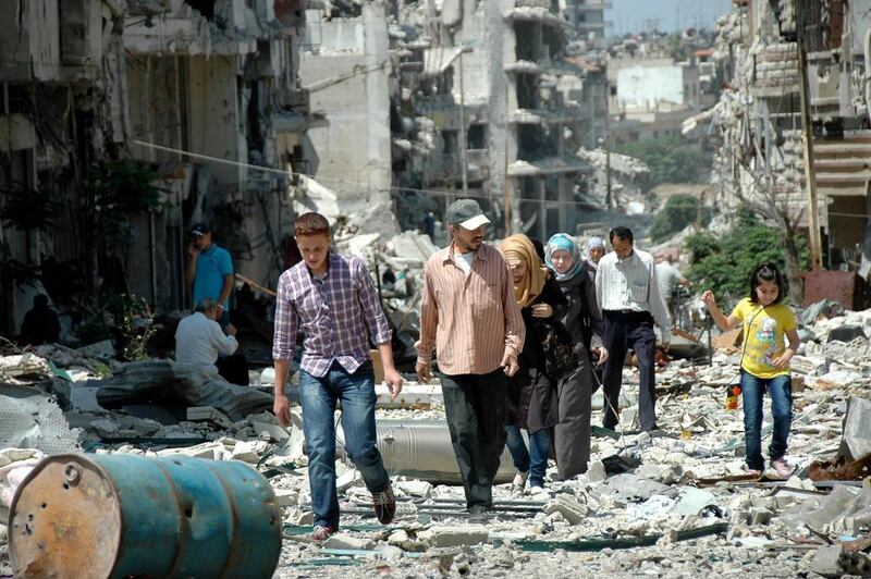 Hundreds of displaced residents returned to inspect the damge to their homes and possessions after rebels vacated areas of the Old City of Homs under a deal with the Bashar Al Assad governmment. AFP / May 10, 2014