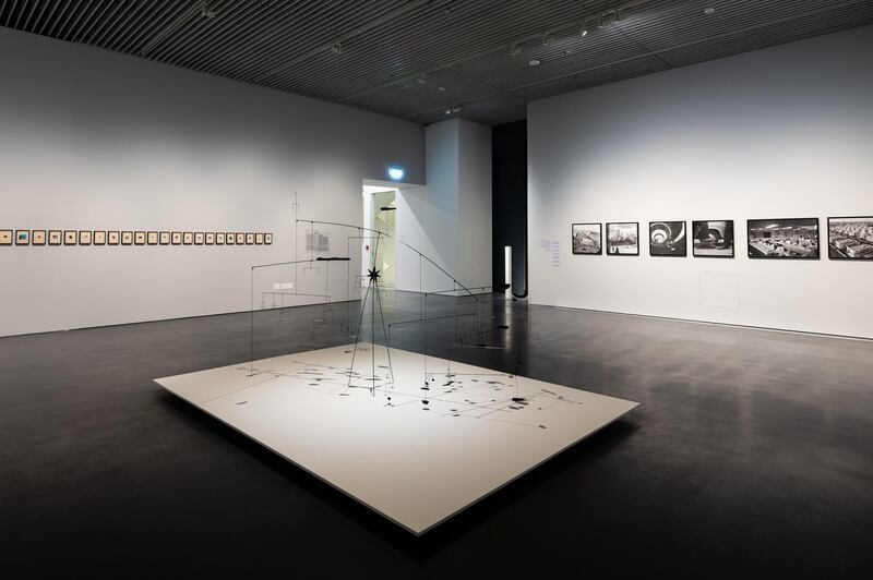 The opening room to the Jameel Arts Centre's Crude sets the stage in the 1950s, when oil was discovered in Iraq -- a moment captured by Latif Al Ani's photographs of the time (on the wall, right). In the centre a mobile by Alessandro Balteo-Yazbeck connects the fine-art patronage of US elites to their political exploits. The shadow of this Calder-like mobile is a map of the major oil fields in Iraq. Along the left-hand wall are Hajra Waheed's found images of oil flares. 