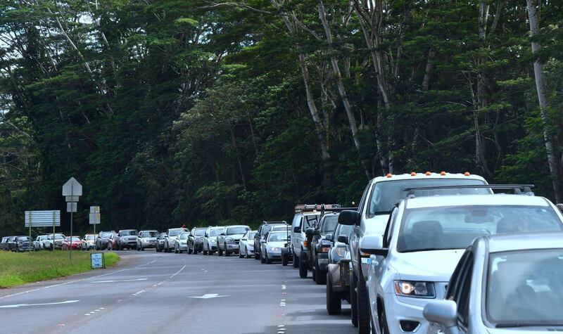 Vehicles head for the intersection of Pahoa and Kapoho Roads as evacuees are allowed to return to their Leilani Estates homes to gather belongings and exit on May 6, 2018, in  Pahoa, Hawaii. Frederic Brown / AFP