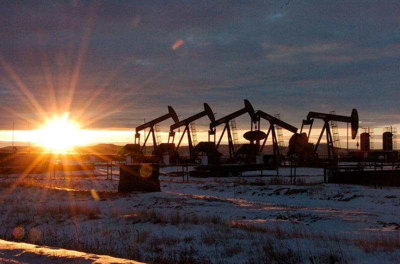 FILE - This Jan. 14, 2015 file photo shows oil pump jacks in McKenzie County in western North Dakota. Dozens of European lawmakers, business executives and union leader called Tuesday for the United States to cut its greenhouse gas emissions by 50% in the coming decade compared with 2005 levels. (AP Photo/Matthew Brown, File)