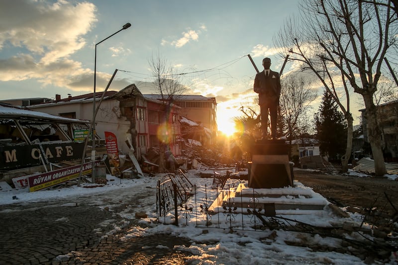 The statue of Mustafa Kemal Ataturk, founder of modern Turkey, is surrounded by damaged buildings in Adiyaman province. AP
