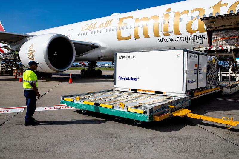Workers unload the doses from an Emirates aircraft. Getty
