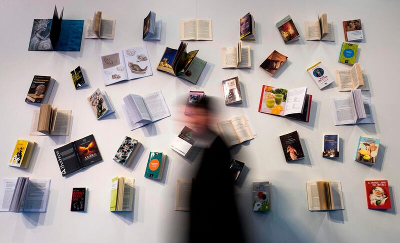 A visitor walks past a book display at the Frankfurt Book Fair on October 13, 2017 in Frankfurt am Main, western Germany.
France is this year's guest of honour at the world's largest book fair, where more than 7,000 exhibitors from more than 100 countries are expected from October 11 to 15. / AFP PHOTO / John MACDOUGALL