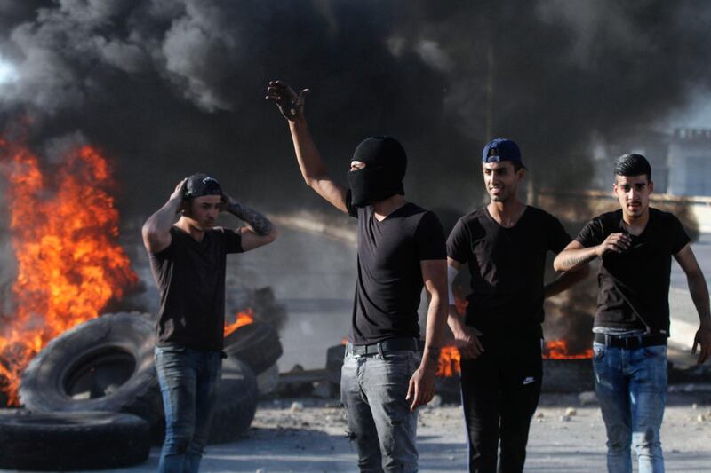 Lebanese protesters block a bridge with flaming tyres on the Sidon-Ghazieh highway amid demonstrations which erupted after the sharp drop of the Lebanese pound on the black market, in the southern coastal town of Ghazieh. AFP