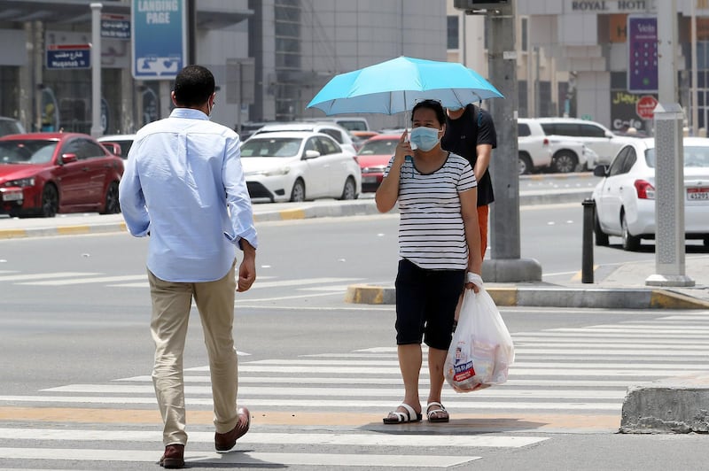 ABU DHABI, UNITED ARAB EMIRATES , June 1 – 2020 :- People wearing protective face mask as a preventive measure against the spread of coronavirus  walking on the streets of Abu Dhabi. UAE government lifts the coronavirus restriction for the residents and businesses around the country. (Pawan Singh / The National) For News/Stock