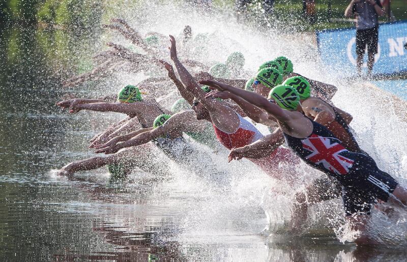 Competitors dive into the water during the men's elite ITU World Triathlon Series in Edmonton, Alberta, Canada. Jason Franson/AP Photo
