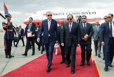 Egyptian President Abdel Fattah El Sisi, centre right, welcomes Turkish President Recep Tayyip Erdogan, centre left, upon his arrival at Cairo Airport on Wednesday.  EPA