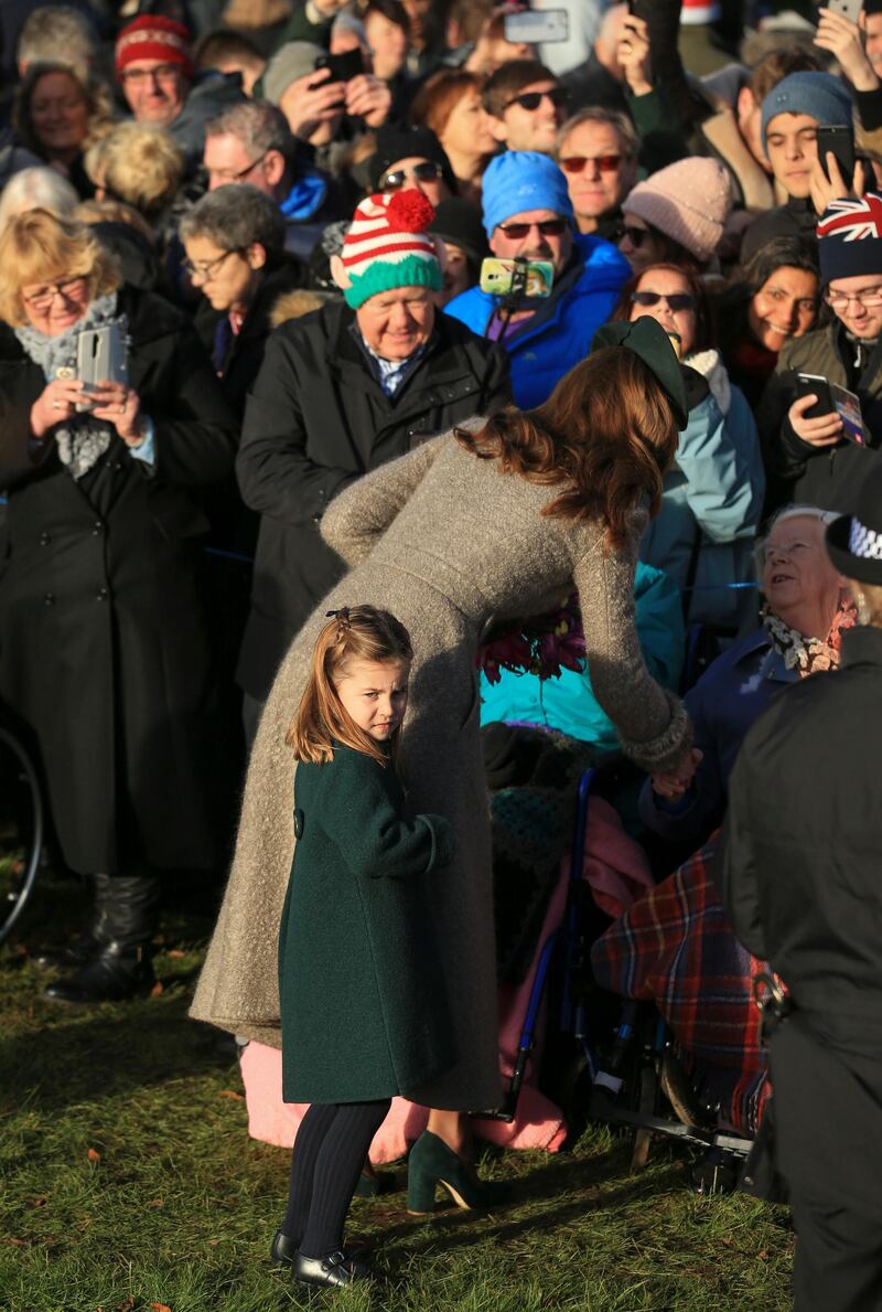 Britain's Catherine, Duchess of Cambridge, centre, and her daughter Princess Charlotte greet the public outside the St Mary Magdalene Church in Sandringham. AP