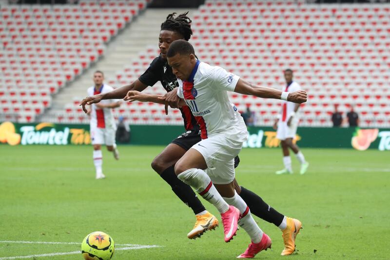 Paris Saint-Germain's forward Kylian Mbappe fights for the ball with Nice's Khephren Thuram. AFP