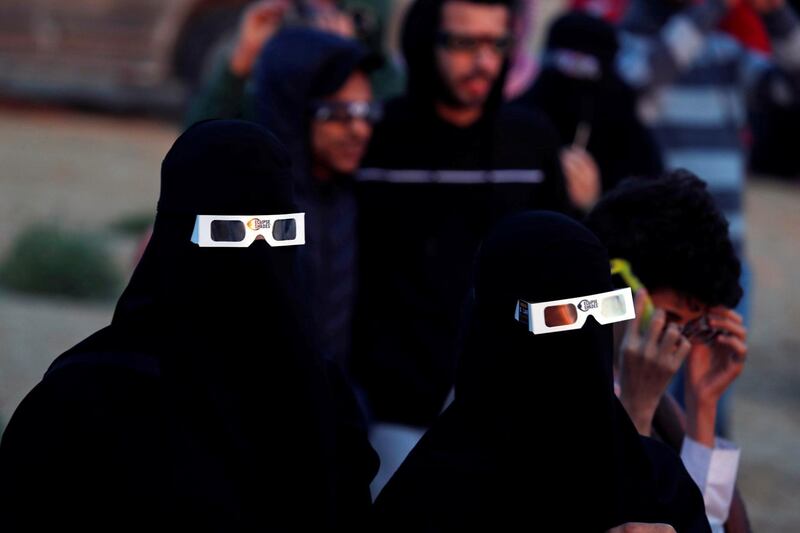 Saudi women wearing special protective glasses monitor the annular solar eclipse on Jabal Arba (Four Mountains) in Hofuf, in the Eastern Province of Saudi Arabia.  REUTERS