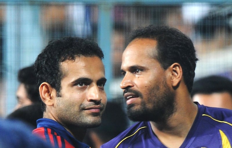 Kolkata Knight Riders batsman Yusuf Pathan (R) shares a light a moment with Delhi Daredevils player and his brother Irfan Pathan as the IPL Twenty20 cricket match between Kolkata Knight Riders and Delhi Daredevils is delayed due to rain at The Eden Gardens Cricket Stadium in Kolkata on April 5, 2012.  RESTRICTED TO EDITORIAL USE. MOBILE USE WITHIN NEWS PACKAGE.  AFP PHOTO/Dibyangshu SARKAR (Photo by DIBYANGSHU SARKAR / AFP)