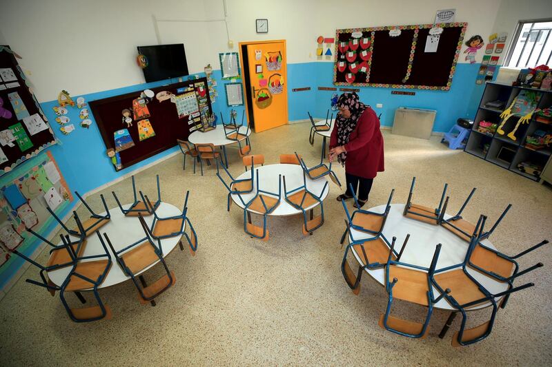 A worker cleans an empty classroom at a school, as Lebanon's education system is in limbo with multiple challenges, in Sidon Lebanon. Reuters