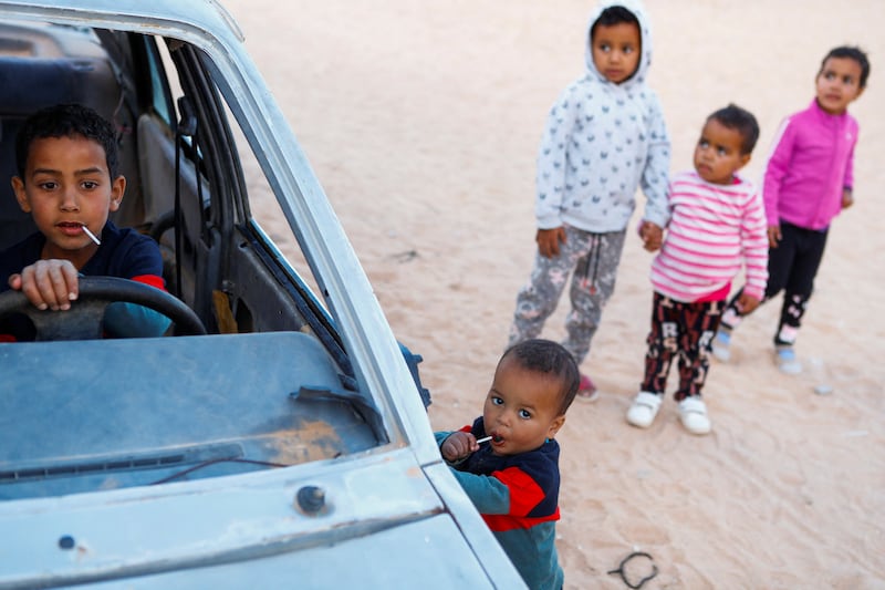 An old car becomes a playground for Sahrawi children in Smara refugee camp, Tindouf, Algeria. Reuters