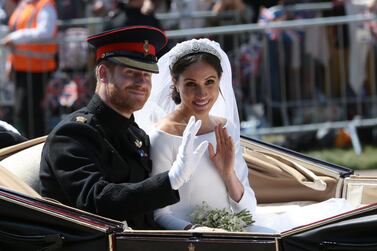 WINDSOR, ENGLAND - MAY 19: Prince Harry, Duke of Sussex and Meghan, Duchess of Sussex wave from the Ascot Landau Carriage during their carriage procession on Castle Hill outside Windsor Castle in Windsor, on May 19, 2018 after their wedding ceremony. (Photo by Aaron Chown - WPA Pool/Getty Images)