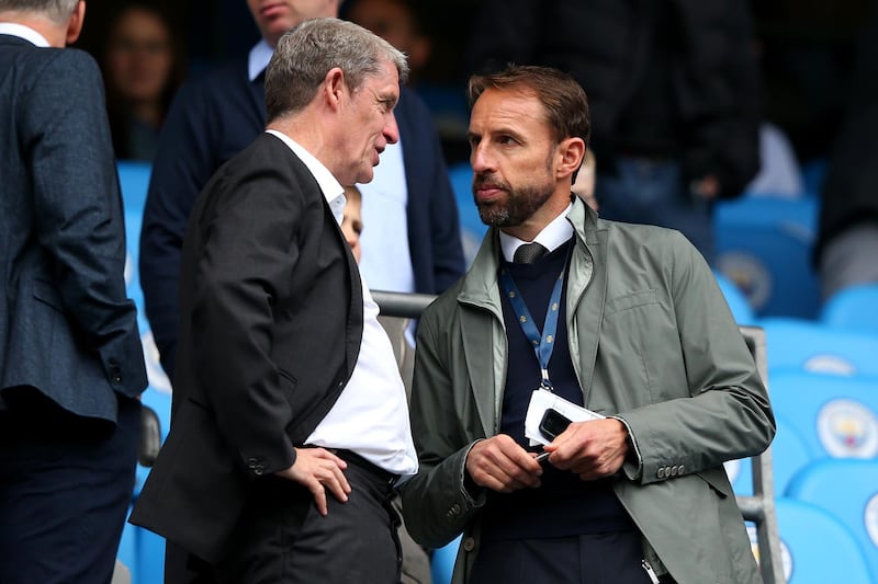MANCHESTER, ENGLAND - AUGUST 19:  Brian Marwood speaks with England Manager Gareth Southgate during the Premier League match between Manchester City and Huddersfield Town at Etihad Stadium on August 19, 2018 in Manchester, United Kingdom.  (Photo by Alex Livesey/Getty Images)