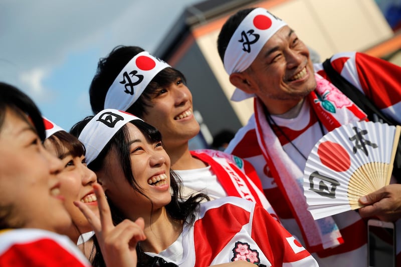 Japanese fans pose for photo as they arrive at Tokyo Stadium. AP Photo