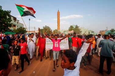 Sudanese people chant slogans and wave national flags as they celebrate after protest leaders struck a deal with the ruling generals on a new governing body, in the capital Khartoum's eastern district of Burri on July 5, 2019. AFP