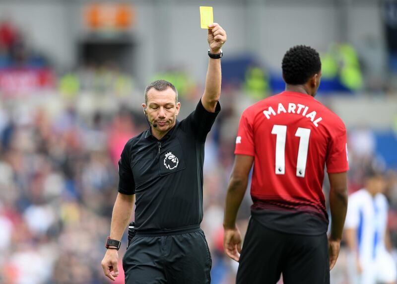 BRIGHTON, ENGLAND - AUGUST 19:  Anthony Martial of Manchester United is shown a yellow card by referee Kevin Friend during the Premier League match between Brighton & Hove Albion and Manchester United at American Express Community Stadium on August 19, 2018 in Brighton, United Kingdom.  (Photo by Mike Hewitt/Getty Images)