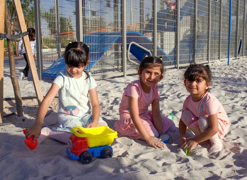 Children enjoy a sandpit in the park 