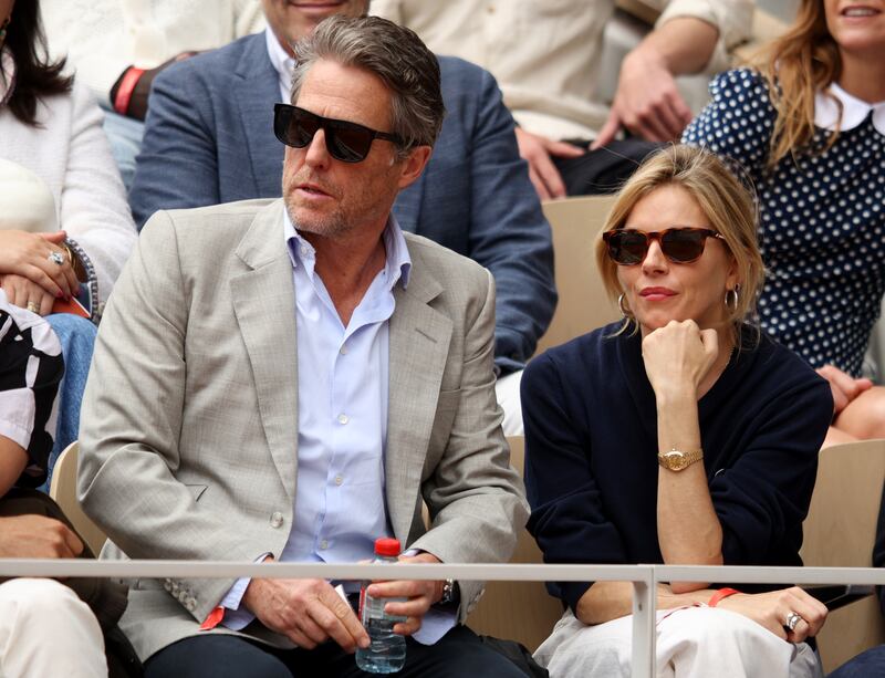 PARIS, FRANCE - JUNE 05: Actors Hugh Grant and Sienna Miller are seen in the stands during the Men's Singles Final match between Rafael Nadal of Spain and Casper Ruud of Norway on Day 15 of The 2022 French Open at Roland Garros on June 05, 2022 in Paris, France. (Photo by Adam Pretty / Getty Images)