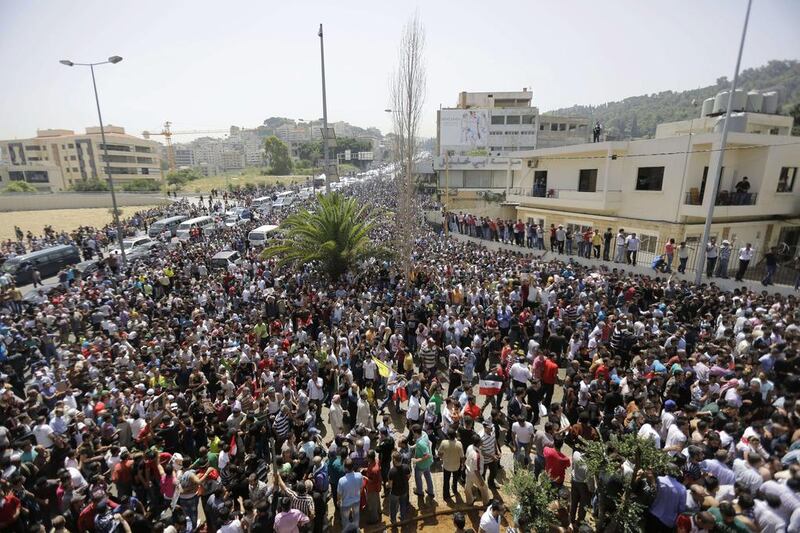 Thousands of Syrain nationals living in Lebanon arrive outside the Syrian Embassy in Yarze east of Beirut on Wednesday  before voting in the upcoming presidential elections in Syria. Filling the streets around the embassy in Beirut, thousands of Syrians turned out to vote in a controversial presidential election that Bashar Al Assad is expected to clinch effortlessly, as civil war rages. Joseph Eid / AFP

