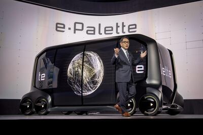 Akio Toyoda, president of Toyota Motor Corp., stands in front of the e-Palette concept vehicle while speaking during the company's press conference at the 2018 Consumer Electronics Show (CES) in Las Vegas, Nevada, U.S., on Monday, Jan. 8, 2018. Toyota Motor Corp., trying to transform itself into a leader of the new driverless economy, unveiled both the concept vehicle and the big-name partners to make it a reality. Photographer: David Paul Morris/Bloomberg