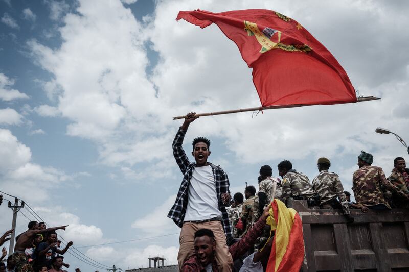 A man waves a Tigray flag as soldiers of Tigray Defence Force (TDF) return in Mekelle.