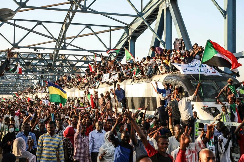 In this Tuesday, April 23, 2019, photo, Sudanese protesters crowd a train in the capital Khartoum. Sudanese activists were holding nationwide protests on Tuesday to press the military to hand over power to a civilian authority after the overthrow of President Omar al-Bashir earlier this month.(AP Photo)