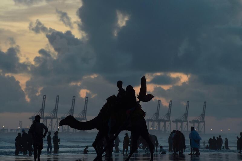 People gather at Sea View Beach violating government bans imposed as a preventive measure to stop the spread of the coronavirus, in Karachi.  AFP