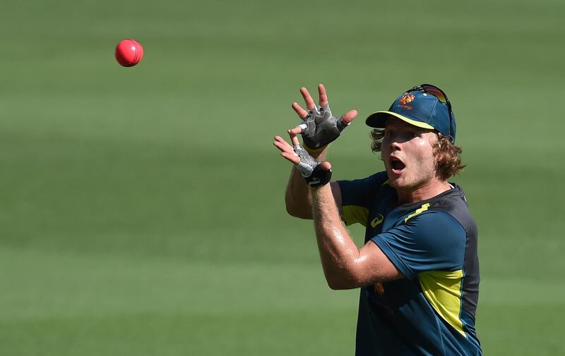 Australia's Will Pucovski catches the ball during a practice session at the Gabba in Brisbane on January 23, 2019, ahead of their first day-night Test match against Sri Lanka on January 24. (Photo by ISHARA S.  KODIKARA / AFP) / --IMAGE RESTRICTED TO EDITORIAL USE - STRICTLY NO COMMERCIAL USE--