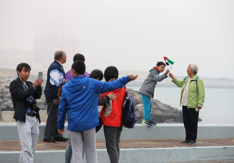 Abu Dhabi, U.A.E., February 8, 2018.  Fog at The Corniche UAE flag area.  Chinese Tourists from Peking China enjoying the Abu Dhabi chilly weather.
Victor Besa / The National
National