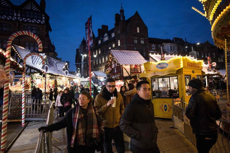 Members of the public make their way through a temporary seasonal Christmas market in Nottingham city centre in Nottingham, central England on November 17, 2017.
Shoppers at Nottingham's Christmas market complained about higher prices and volunteers handed out food parcels just a few streets away, even as retailers sought to dispel Brexit gloom with Black Friday sales. Britain is gripped by a cost of living crisis sparked in part by the nosedive in the value of the pound after the country voted for Brexit in June 2016, pushing up the price of imported foodstuffs. / AFP PHOTO / OLI SCARFF / TO GO WITH AFP STORY by Kenza BRYAN