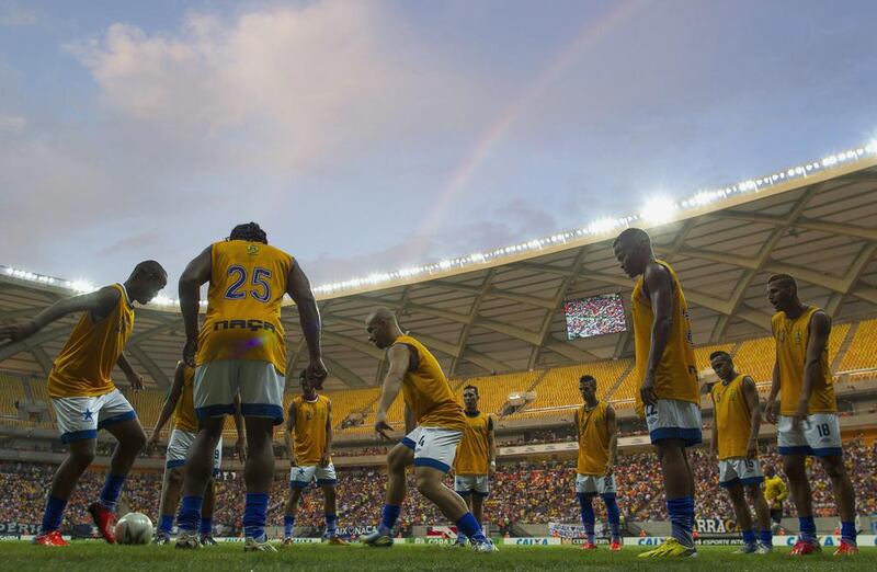 Players from Nacional of Amazonas warm up in the Arena Amazonia Vivaldo Lima before the stadium's inaugural match between the Nacional and Remo on Sunday. Bruno Kelly / Reuters / March 9, 2014