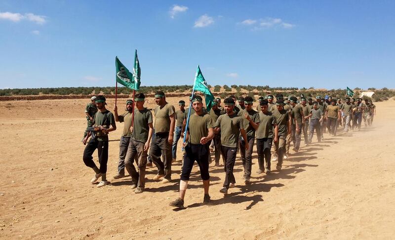 Rebel fighters of the Yarmuk Brigade train on the outskirts of the southern Syrian city of Deraa. Mohammed Al Fares / AFP