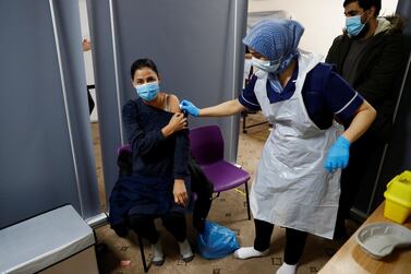 Abida Bi receives a coronavirus disease vaccine from nurse Zenub Mahood at a mosque in Bradford, UK. Reuters 