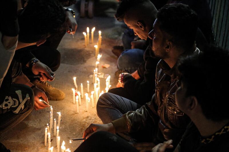 Shiite Muslim pilgrims light candles outside the Shrine of Imam Mohammed al-Mahdi during the Shaabaniya ceremony marking the middle of the Islamic month of Shaban and two weeks before the start of the holy fasting month of Ramadan, and on which Twelver Shiites commemorate the birth of Imam Mahdi (the sect's final Imam), in Iraq's central holy shrine city of Karbala on March 28, 2021.  / AFP / Mohammed SAWAF
