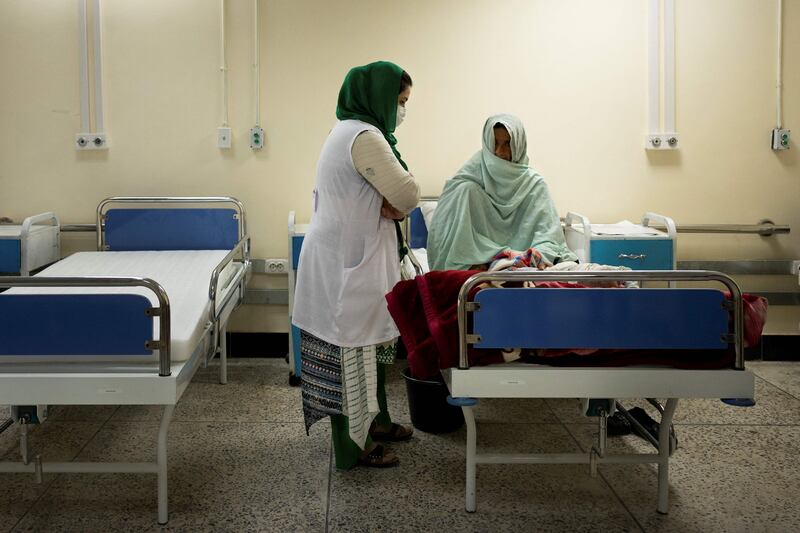 A nurse tends to a mother and her infant at the therapeutic feeding unit of NGO ‘Action contre La Faim’ in Lashkar Gah.