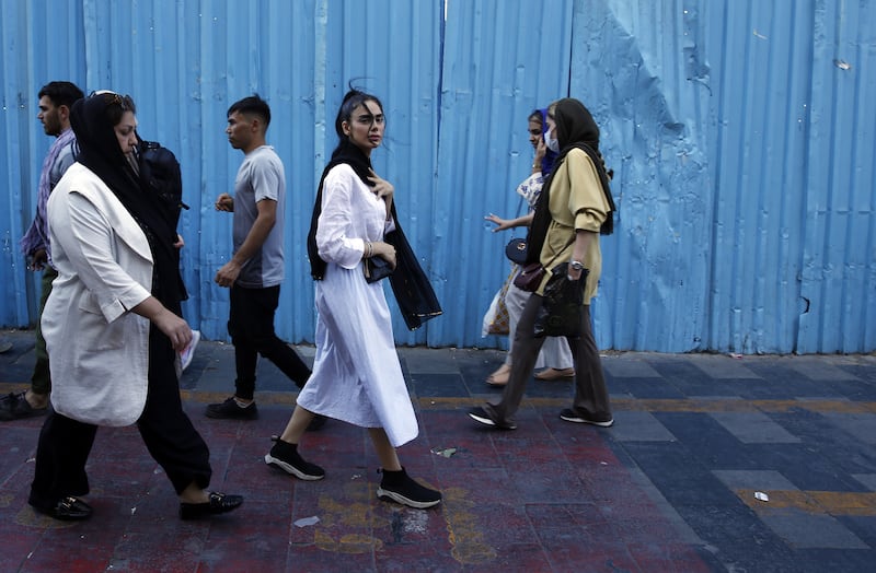 Iranian women, some without the mandatory headscarf, on in a street in Tehran. EPA