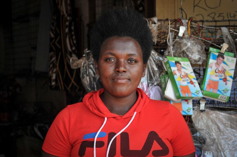 Grace Twisimire, 25, sits in her once-thriving shop selling clothes and plastic shoes in the capital Kampala, Uganda, June 20. The Covid-19 pandemic means that millions of women in Africa and other developing regions could lose years of success in contributing to household incomes, asserting their independence and expanding financial inclusion. Ronald Kabuubi / AP